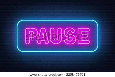 Pause neon sign on brick wall background.