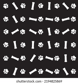 Paw and bone pattern on black background.