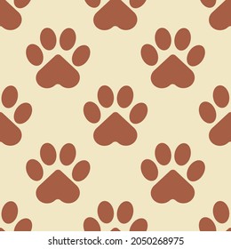 Paw of a brown cat, puppy or bear on a beige background. Seamless patterns for modern textiles and fabrics, wrapping paper, decorative pillows. Vector.