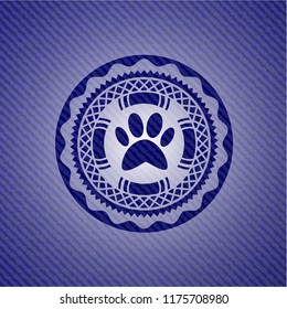 paw icon inside badge with denim background