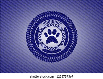paw icon inside badge with denim background