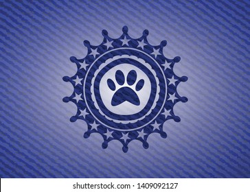 paw icon inside badge with denim texture