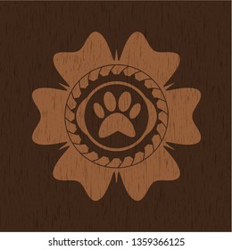 paw icon inside badge with wood background