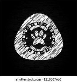 paw icon inside chalkboard emblem written on a blackboard
