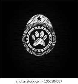 paw icon inside chalkboard emblem written on a blackboard