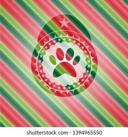 paw icon inside christmas colors emblem.