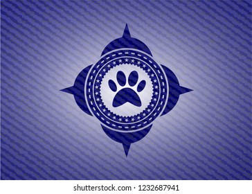 paw icon inside emblem with denim texture