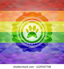 paw icon inside emblem on mosaic background with the colors of the LGBT flag