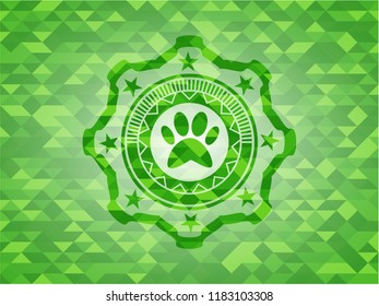 paw icon inside green emblem with mosaic ecological style background