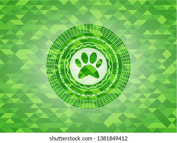 paw icon inside green emblem with triangle mosaic background