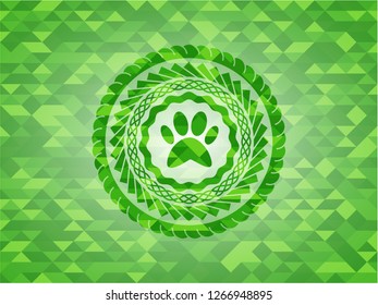 paw icon inside green mosaic emblem