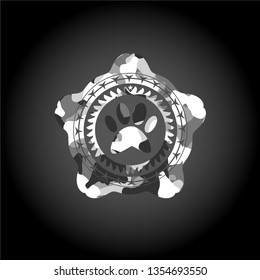 paw icon inside grey camouflaged emblem
