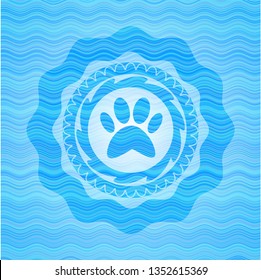 paw icon inside light blue water emblem background.