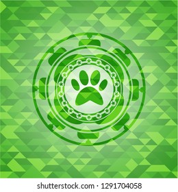 paw icon inside realistic green mosaic emblem
