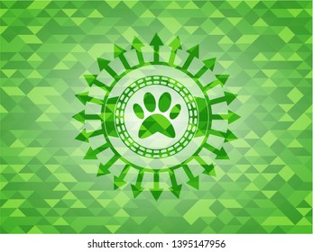 paw icon inside realistic green emblem. Mosaic background