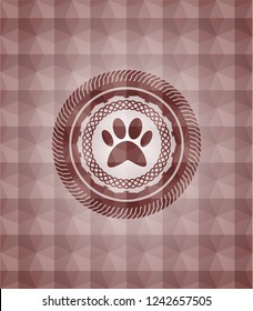 paw icon inside red seamless emblem or badge with abstract geometric pattern background.