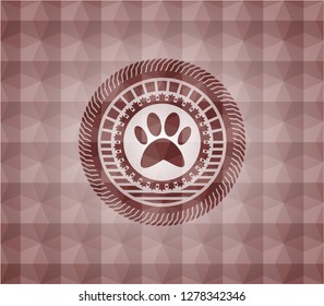 paw icon inside red seamless geometric emblem.