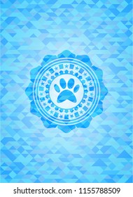 paw icon inside sky blue emblem with triangle mosaic background