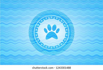 paw icon inside sky blue water wave badge background.