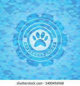paw icon inside sky blue emblem with triangle mosaic background