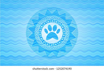 paw icon inside water wave concept badge.