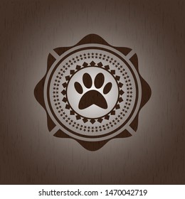 paw icon inside wood badge or emblem