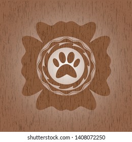 paw icon inside wood emblem