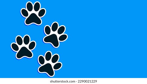 Paw prints of Pets on blue background with copy space for your text.