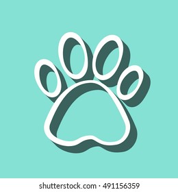 Paw vector icon with shadow. White illustration isolated on green background for graphic and web design.