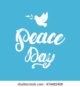 Peace Day hand written calligraphy lettering poster or card with hand drawn dove and olive branch on blue background. Brush ink texture. Vector illustration.