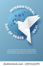 Peace dove in origami paper cut style on global with wording of the Peace day on blue paper pattern background.