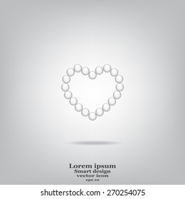 Pearl beads as heart on a white background