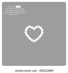 Pearl beads as heart on a white background