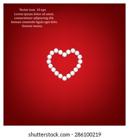 Pearl beads as heart on a white background