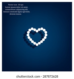 Pearl beads as heart on a white background