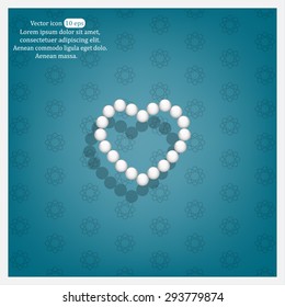 Pearl beads as heart on a white background