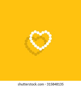 Pearl beads as heart on a white background