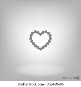 Pearl beads as heart on a white background