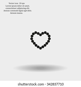 Pearl beads as heart on a white background