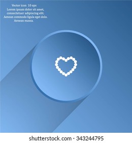 Pearl beads as heart on a white background