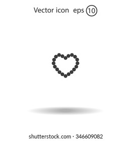 Pearl beads as heart on a white background