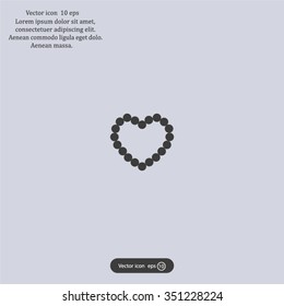 Pearl beads as heart on a white background