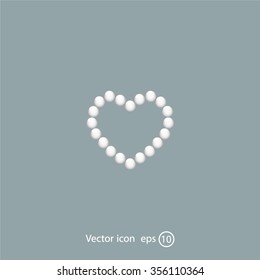 Pearl beads as heart on a white background