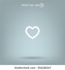 Pearl beads as heart on a white background