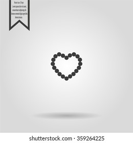 Pearl beads as heart on a white background