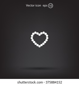 Pearl beads as heart on a white background