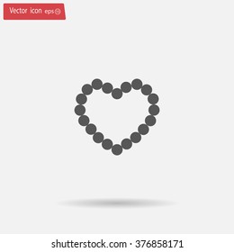 Pearl beads as heart on a white background