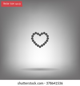 Pearl beads as heart on a white background