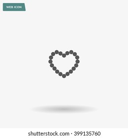 Pearl beads as heart on a white background