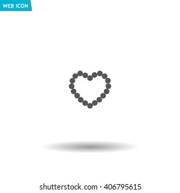 Pearl beads as heart on a white background